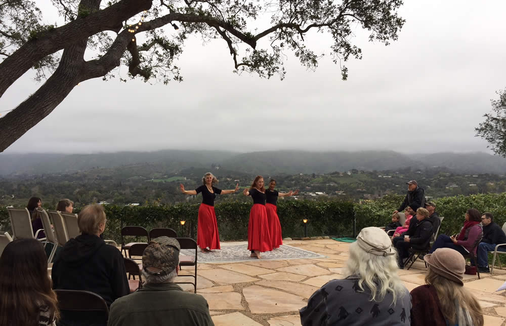 group event at ojai retreat cultural center with dancers in red skirts